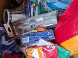 a cardboard box filled with school supplies and a pair of scissors