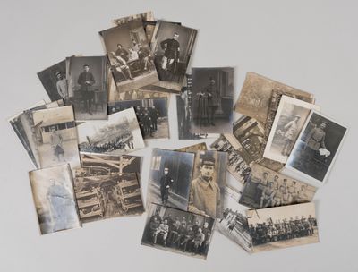 several old black and white photographs of men and women on a table