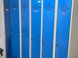 several blue lockers are lined up in a row in a room