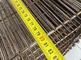 a measuring tape on the side of a metal cage
