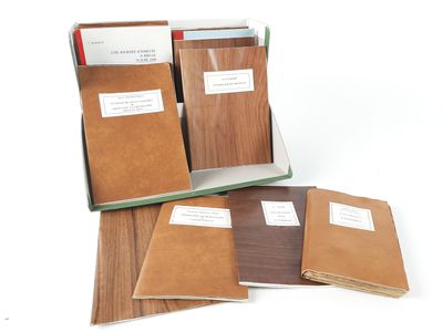 several books are stacked on top of each other on a white surface
