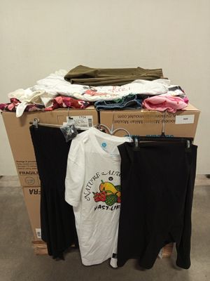 a pile of clothes on a carton in a room