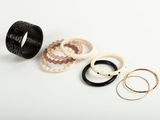 a group of rings and bracelets sitting on top of a white surface