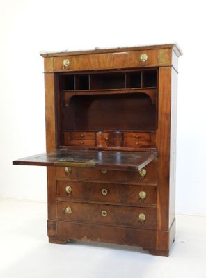a wooden cabinet with a marble top on a white floor