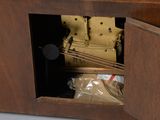a clock that is sitting inside of a wooden box