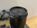 a black camera lens sitting on a table next to a pair of scissors