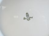 une assiette blanche sur laquelle figure un logo en noir et blanc