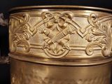 a gold vase that is sitting on a table