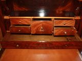 a wooden desk with drawers and a mirror in it