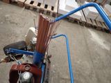 a blue bike with a bunch of sticks on the back