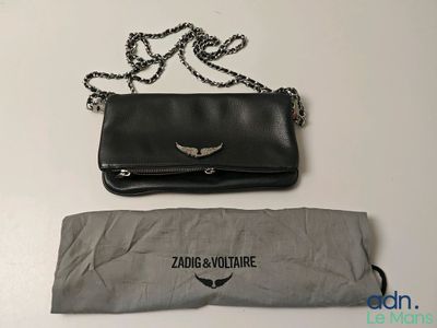 a black purse and an umbrella sitting on a table