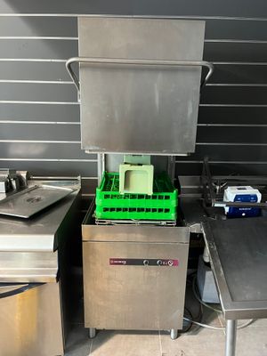 stainless steel counter top with a dishwasher and a sink in a commercial kitchen