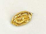 an image of a gold plated brooch depicting a woman ' s face