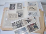a lot of old books on a table with pictures on them