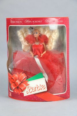 doll in a red box with a red ribbon and a red bow