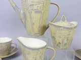 four cups and two saucers and a teapot
