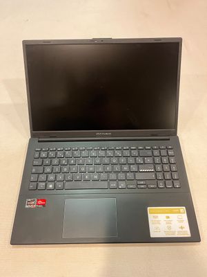 a laptop computer sitting on top of a table next to a keyboard