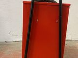 a red cabinet with a black handle and a black handle on it