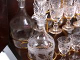 bottles and glasses on a table with a gold handle