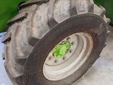 a tractor tire that is sitting in the snow