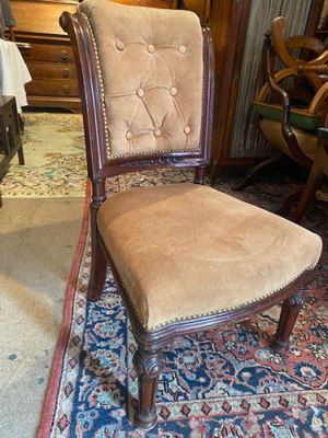 a chair that is sitting on a rug in a room
