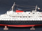 a model of a ship on a stand on a black background