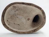 a white vase that has a hole in the middle of it