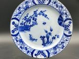 an image of a blue and white plate with birds and flowers on it