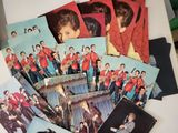 many pictures of a group of young men on a table