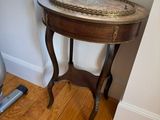 a small table with a tray on it next to a window