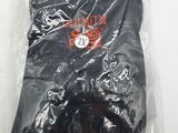 black pants in a plastic bag on a white surface