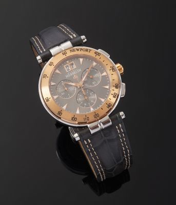 a close up of a watch on a black surface with a black background