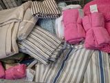 a metal basket filled with lots of clothes and blankets
