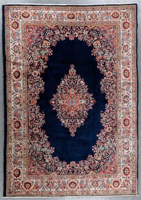 an antique persian rug with a medallion design on a blue ground