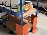 a shelf with many books on it in a warehouse