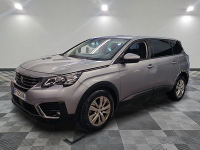 a grey suv parked in a room with a checkered floor