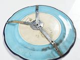 a blue and white plate with a clock on it