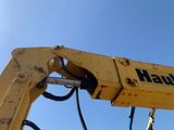 a close up of a yellow machine with a blue sky in the background