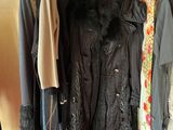 a lot of clothes hanging on a rack in a room