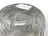 a clear glass jar with a lid on a white surface