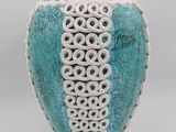 a blue and white vase with a decorative design on it