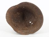 an old rusted metal object on a white surface