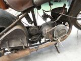 an old motorcycle that is sitting on the ground
