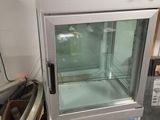 a small refrigerator that is sitting on the floor in a room