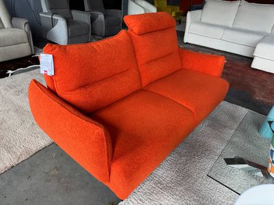 un canapé orange qui trône au milieu d'une pièce