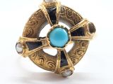 an image of a gold ring with a turquoise stone in the center