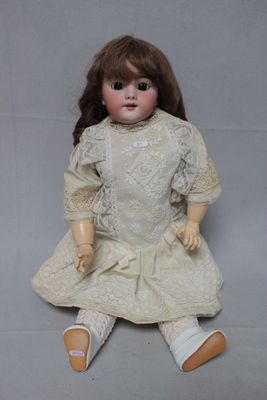 a doll that is sitting on the floor with a white dress