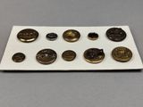 a white plate topped with lots of different types of buttons