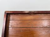 an old wooden box with a handle on it