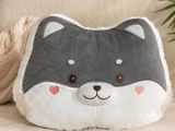 a pillow with a cat face on it sitting on a couch